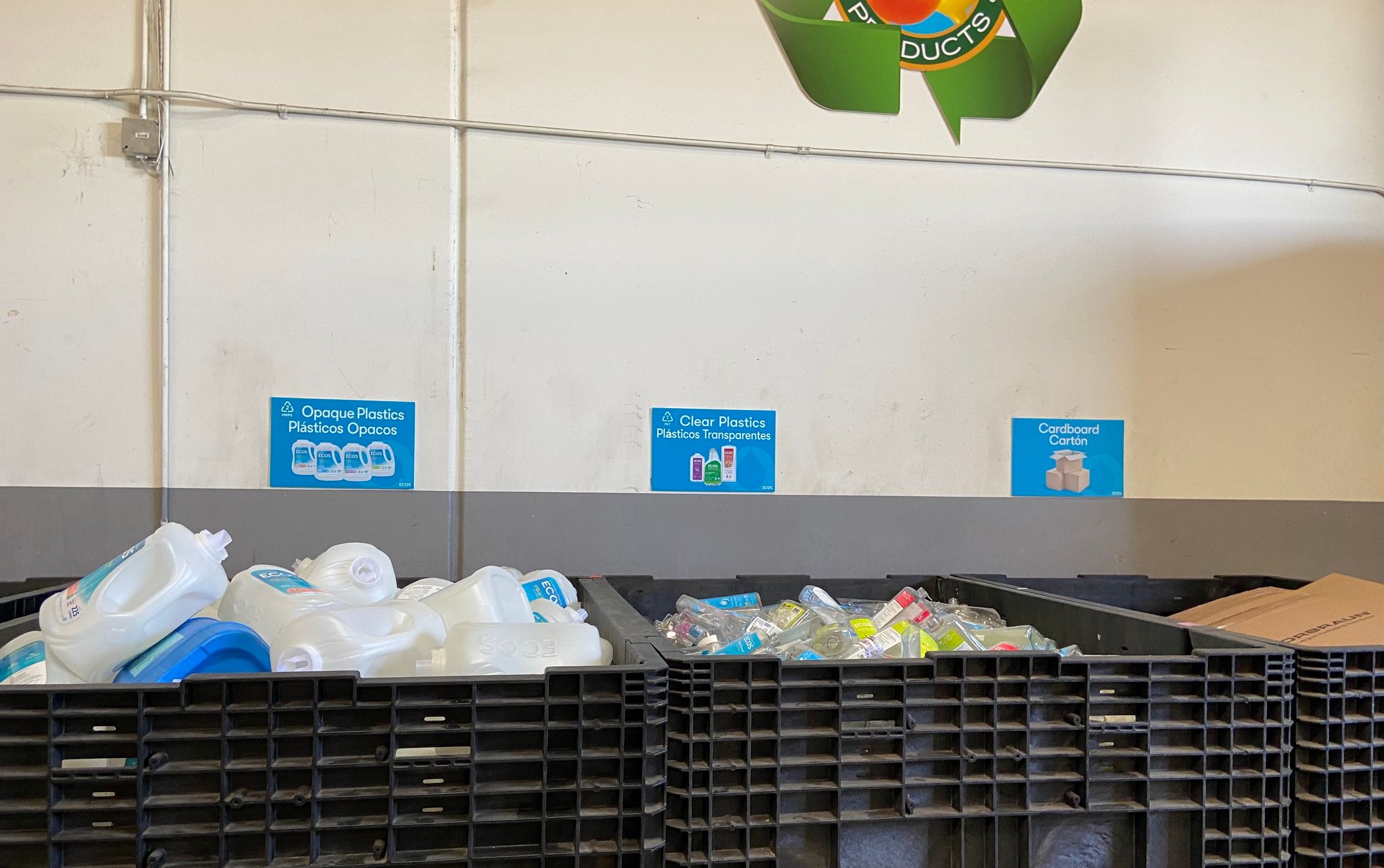 Recycling bins at Ecos separated with separate bins for opaque plastics, clear plastics and cardboard cartons