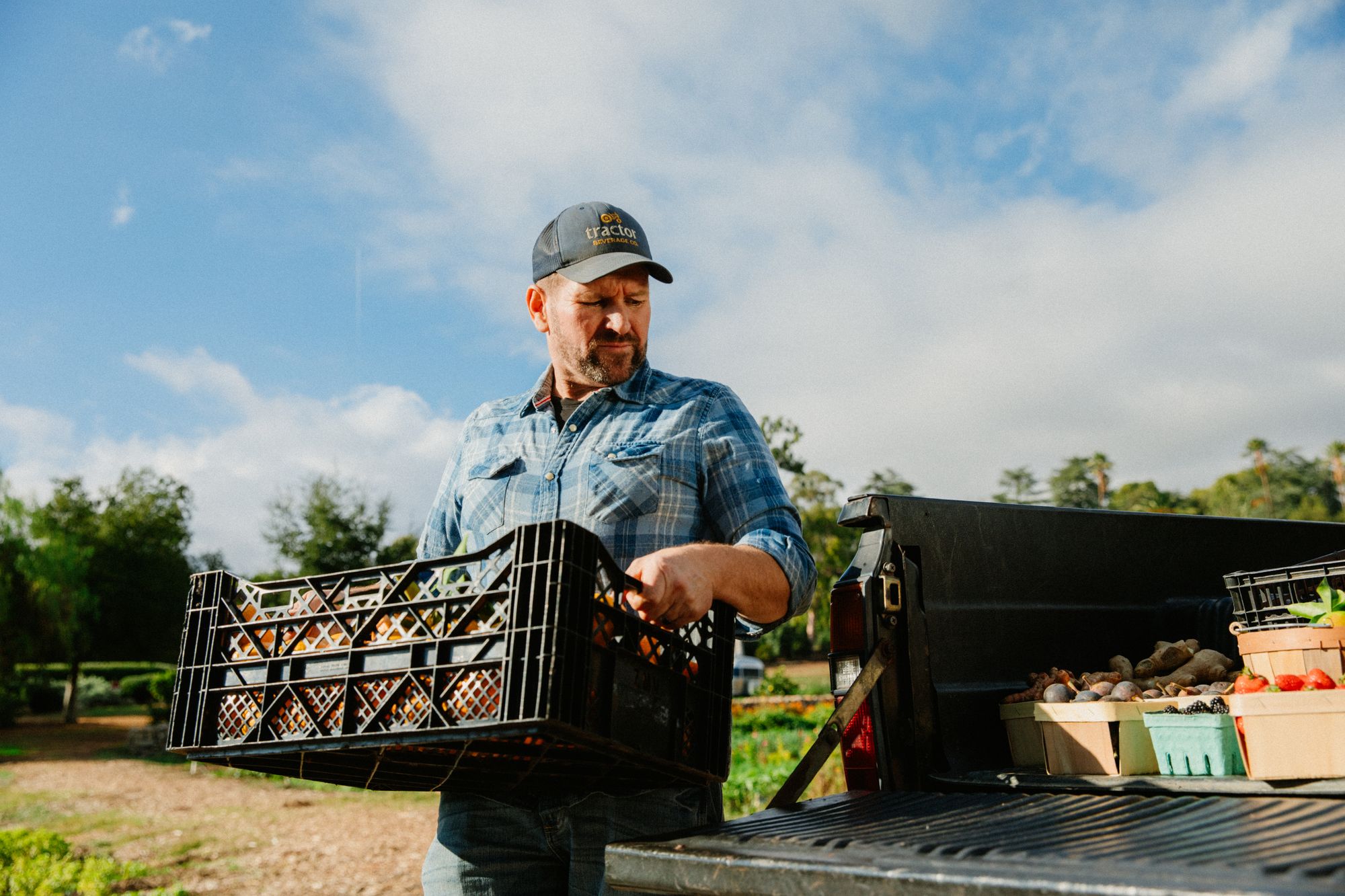 Person loading produce from farm onto a pickup truck